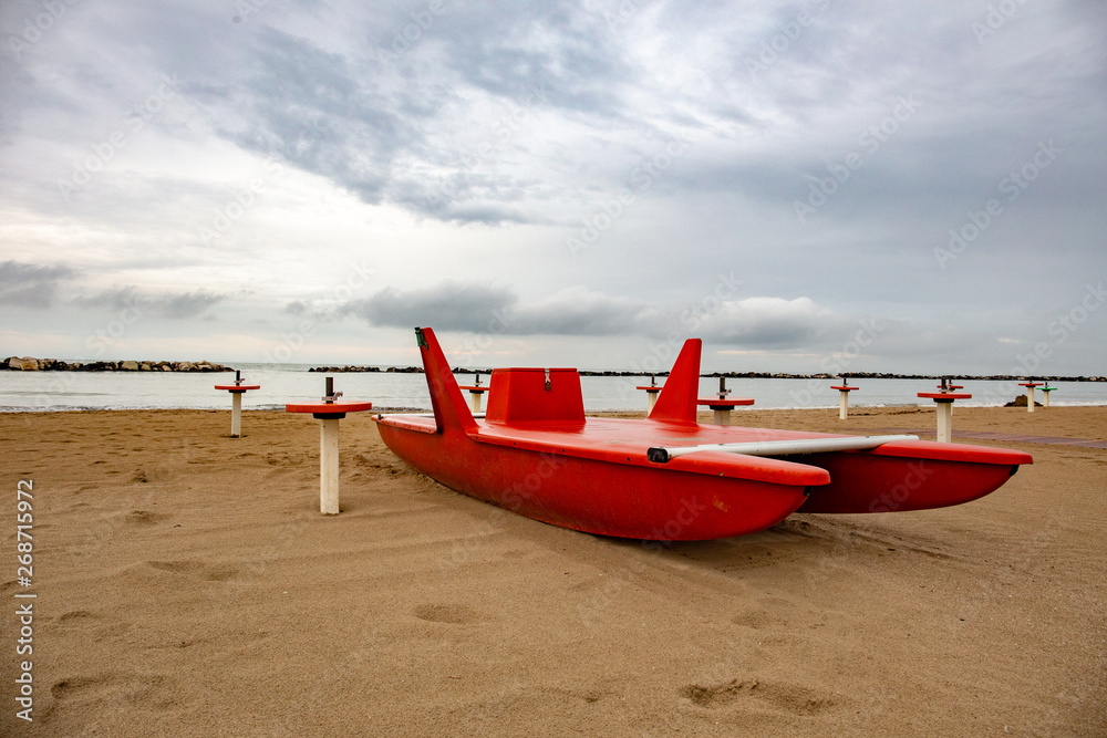 Lifeguard rescue vessel in a beach in the Riviera Romagnola area: italian bay watch Lifeguard rescue vessel in a beach in the Riviera Romagnola area: italian bay watch