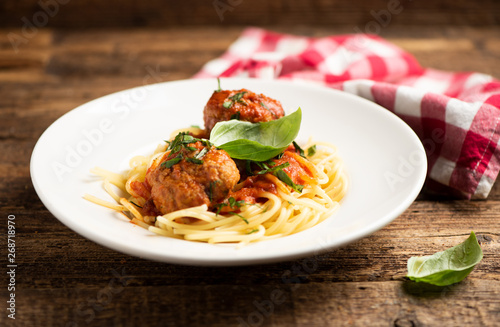 Beef meatballs with bolognese sauce and spaghetti.