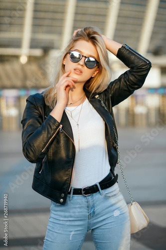 Urban shoot of young stunning woman wearing glasses and black jacket © vpavlyuk