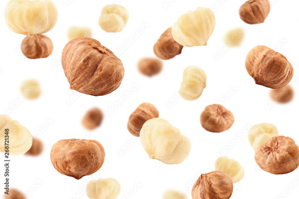 Falling hazelnut peeled, isolated on white background, selective focus Falling hazelnut peeled, isolated on white background, selective focus
