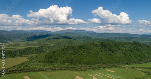 Mountains covered with green forest and river. Carpathians. View from above. Picture taken with a drone.