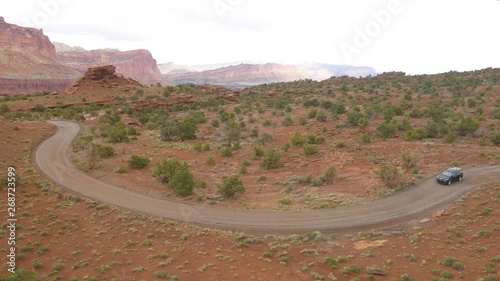 SUV Driving on a Dirt Road photo