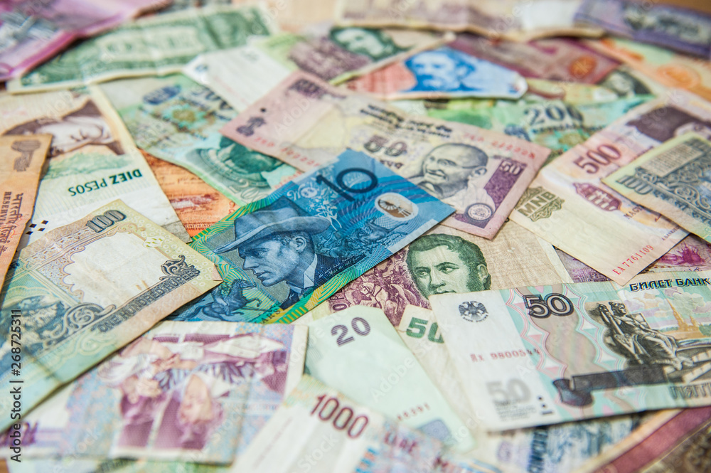 Blue money bill in front of different international banknotes Blue money bill in front of different international banknotes