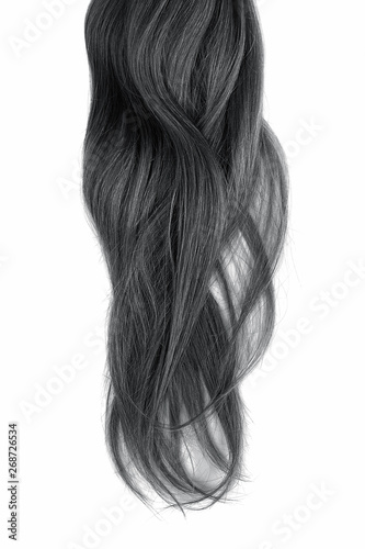 Black hair isolated on white background. Long wavy ponytail