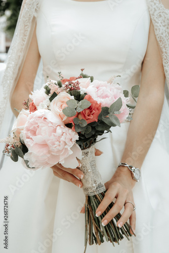 wedding bouquet in bride's hands. Delicate wedding bouquet of roses