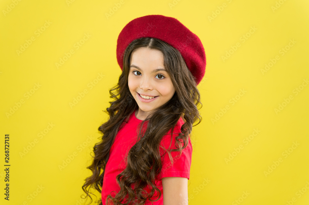 Smiling child. Kid girl long healthy shiny hair wear red hat. Little girl with long hair. Kid happy cute face adorable curly hair yellow background. Lucky and beautiful. Beauty tips for tidy hair Smiling child. Kid girl long healthy shiny hair wear red hat. Little girl with long hair. Kid happy cute face adorable curly hair yellow background. Lucky and beautiful. Beauty tips for tidy hair