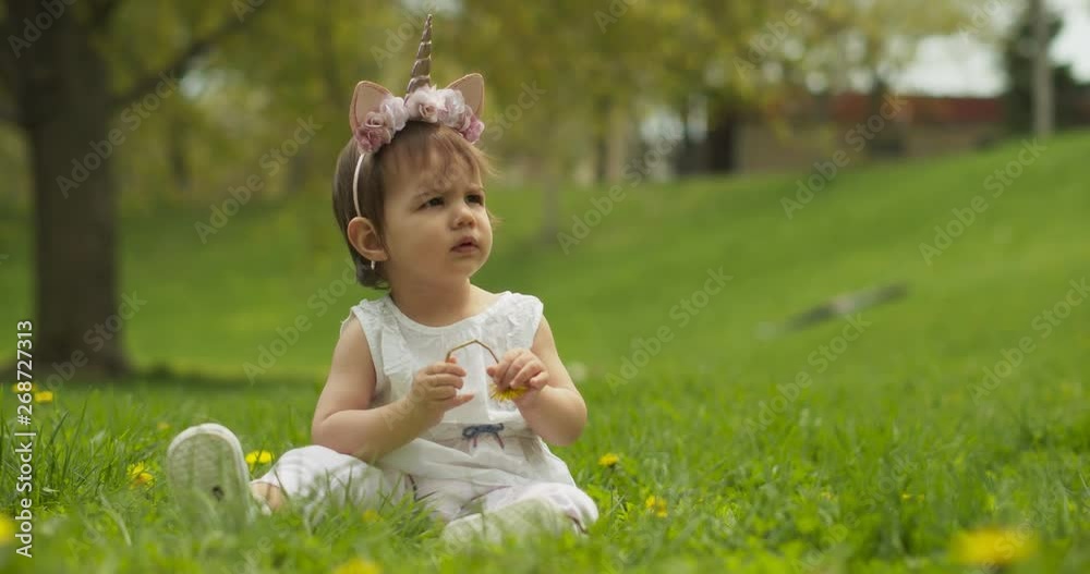 Adorable baby girl at the park dressed as a unicorn. Shot in 4K RAW on a cinema camera. Adorable baby girl at the park dressed as a unicorn. Shot in 4K RAW on a cinema camera.