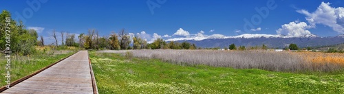 Canvas Print Jordan River Parkway Trail, Redwood Trailhead bordering the Legacy Parkway Trail, panorama views with surrounding trees and silt filled muddy water along the Rocky Mountains, Salt Lake City, Utah