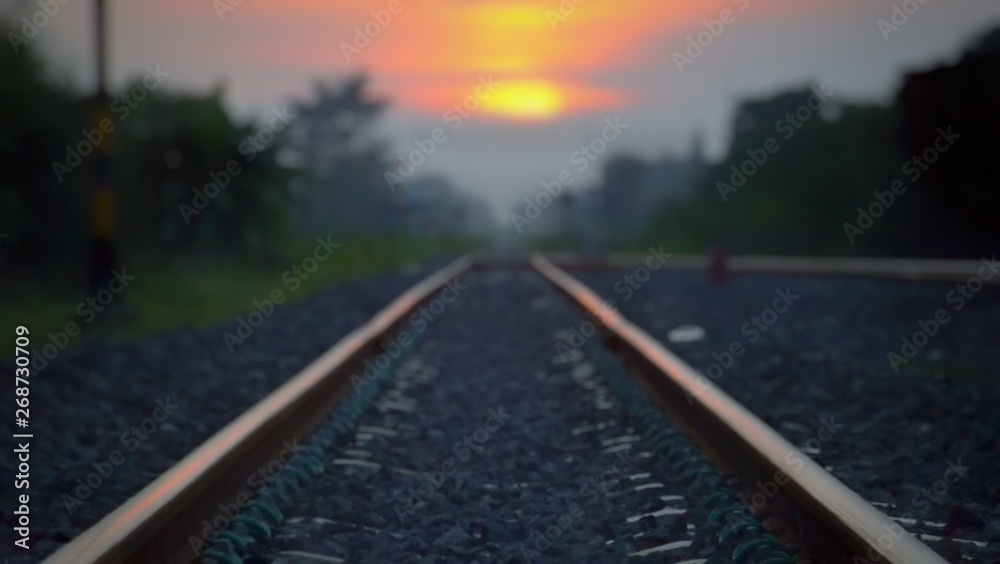 Blurred images in the atmosphere on a long train track  And the sun is going to fall in the evening
