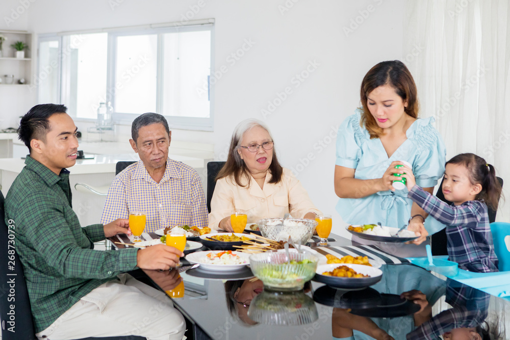 Big family eating meals together at home