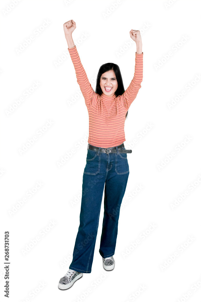 Excited young woman raising hand on studio Excited young woman raising hand on studio