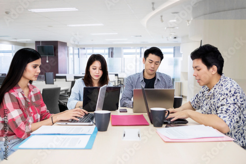 Group of young freelancers working in the office