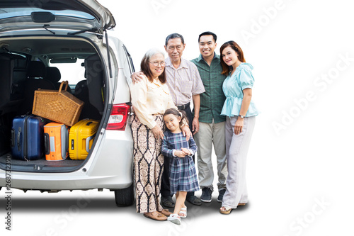 Happy big family standing near their car