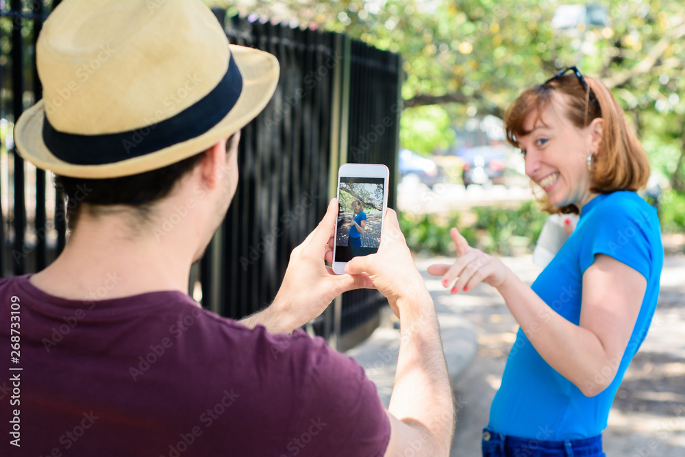 Young couple taking photo with smartphone camera. Young couple taking photo with smartphone camera.