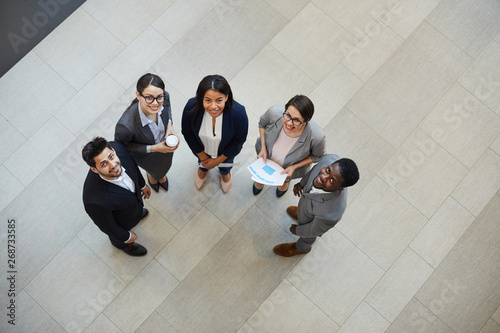 Fotografie Directly above view of happy confident young multi-ethnic business professionals