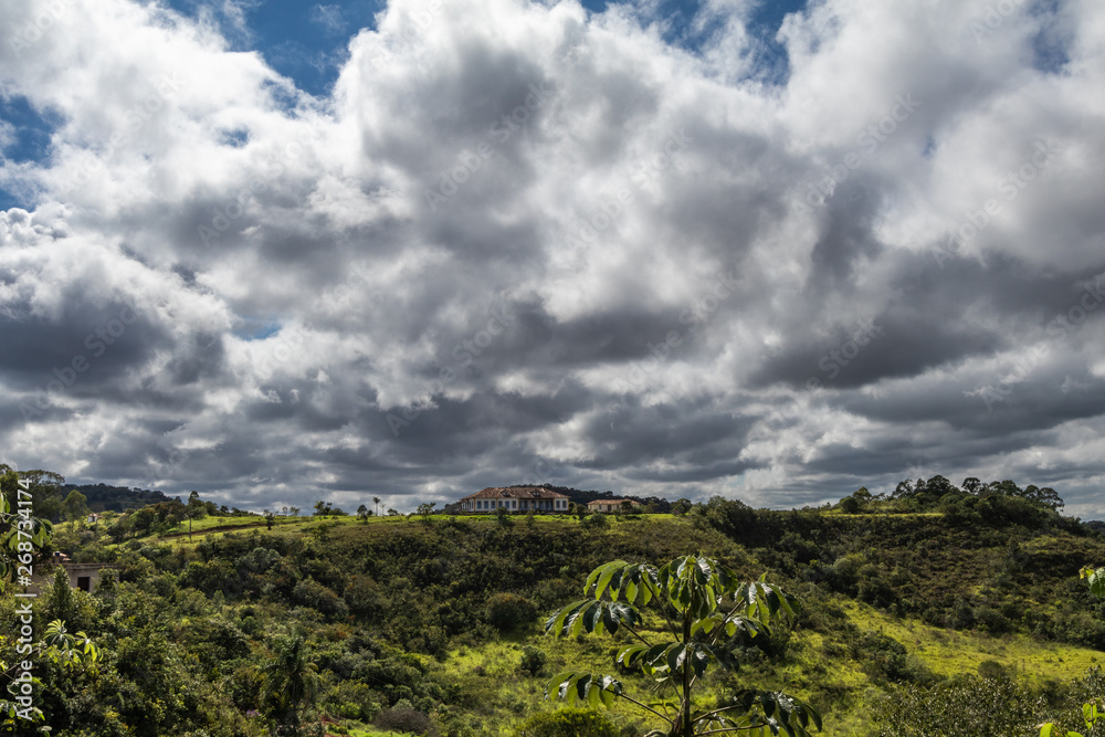 Tiradentes, Minas Gerais, Brazil - March 29, 2019: Imposing colonial-style house on the top of a hill in the outskirts of the city of Tiradentes. Tiradentes, Minas Gerais, Brazil - March 29, 2019: Imposing colonial-style house on the top of a hill in the outskirts of the city of Tiradentes.
