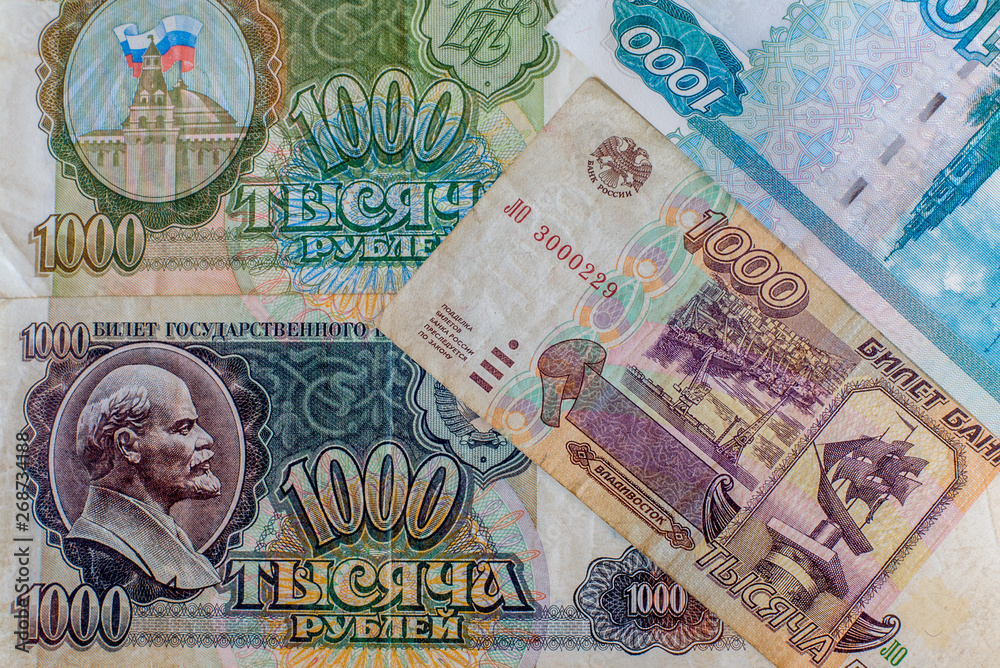 Obraz premium Russian ruble. Russian and Soviet money of different years. Banknotes in a thousand rubles of different years. Money USSR transition period. Cash. Background texture.