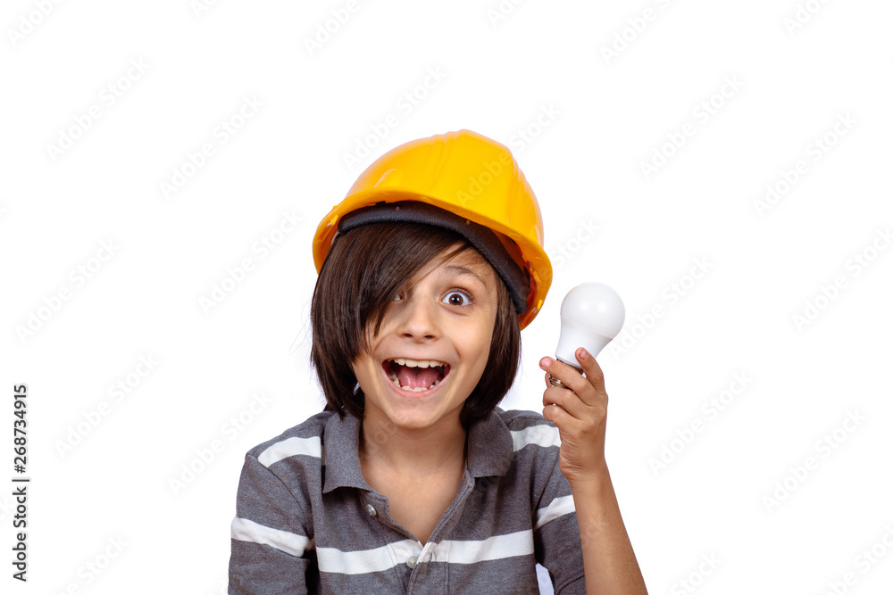 Little boy with construction helmet and holding light bulb. Little boy with construction helmet and holding light bulb.