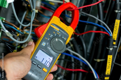 clamp meter check current in panel photo