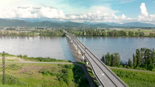 Aerial view of the Mission River bridge with cars travelling over it on a sunny day. photo