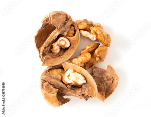 Peeled walnuts with broken shell isolated on white background. Macro. Walnuts close-up.
