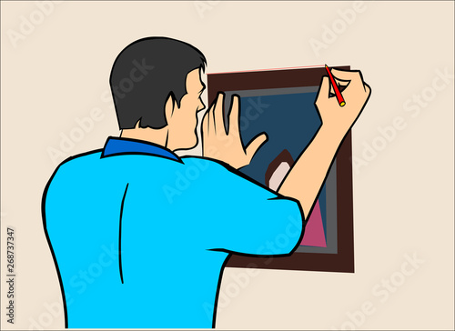 man installing a picture on the wall