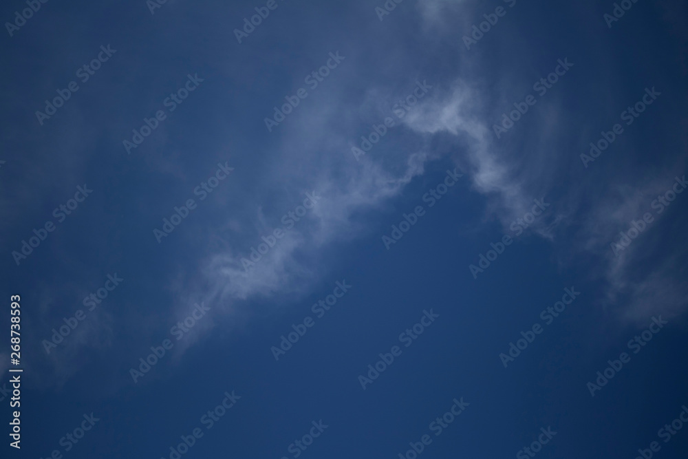 Obraz premium Fluffy Little Clouds. Blue skies and wispy clouds on a gorgeous summer day.