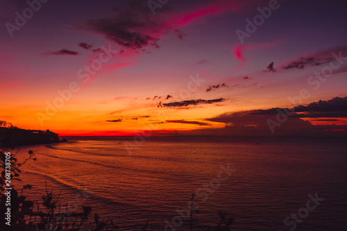 Bright sunset with ocean in tropical island © artifirsov