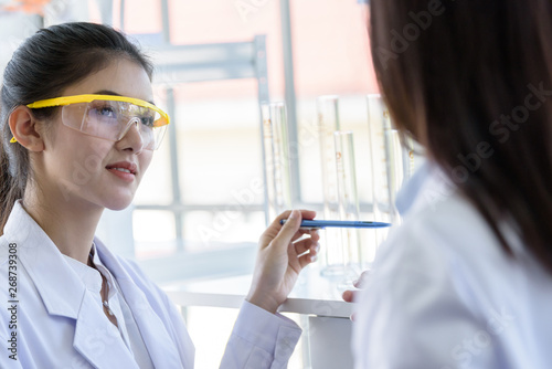 Asian young female working and research scientist together.