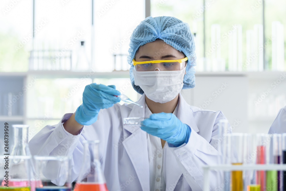Asian young girl student scientist researching and learning in a laboratory. Asian young girl student scientist researching and learning in a laboratory.