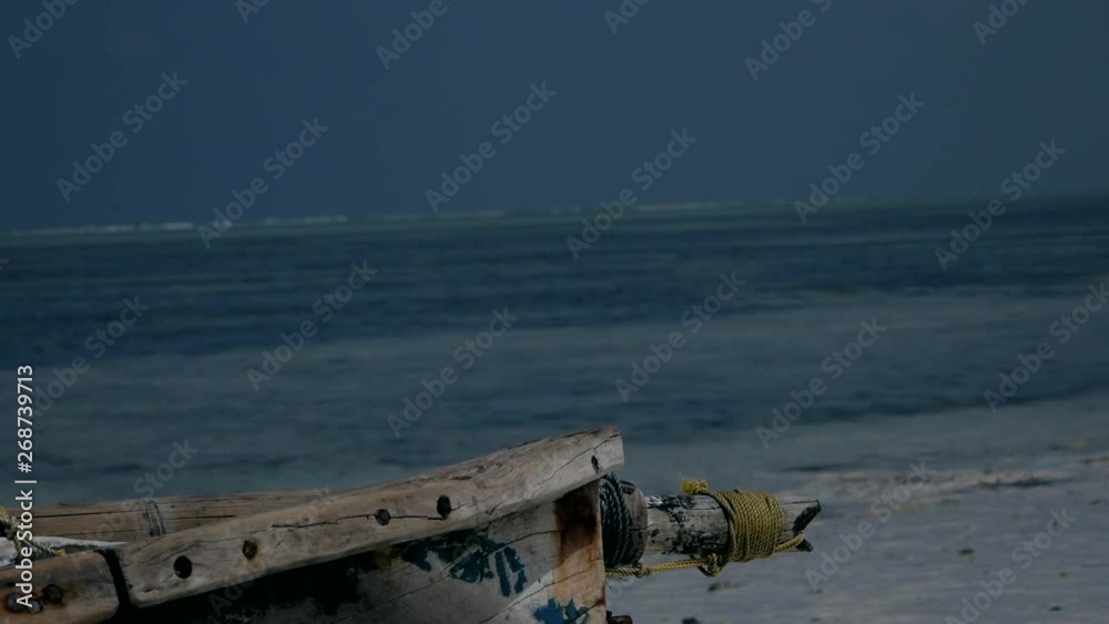 a lonely wooden boat by the sea. turquoise water in Indian ocean a lonely wooden boat by the sea. turquoise water in Indian ocean