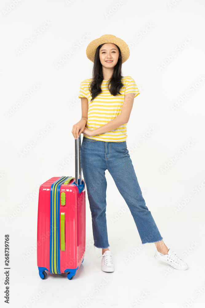 Beautiful young woman smiling and pulling pink color luggage isolated on white background.Asian woman going to summer vacation.Travel trip funny. Beautiful young woman smiling and pulling pink color luggage isolated on white background.Asian woman going to summer vacation.Travel trip funny.