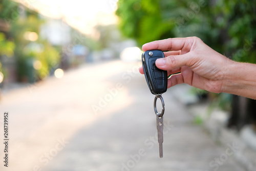 Young businessmen submit car keys to