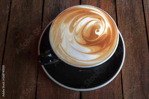Latte art coffee cup of on wooden background