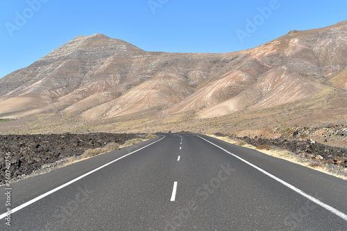 Asphalt road with a volcanic mountain view in Lanzarote Island, Canary Islands, Spain