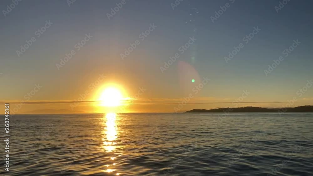 Beautiful sunrise shot from the boat with calm water and colorful sky Beautiful sunrise shot from the boat with calm water and colorful sky