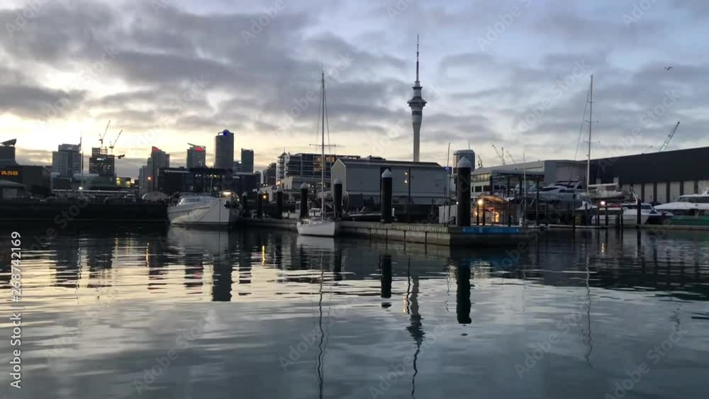 SLOW MOTION - Pan shot of Auckland marina in the morning with Sky Tower in the background SLOW MOTION - Pan shot of Auckland marina in the morning with Sky Tower in the background