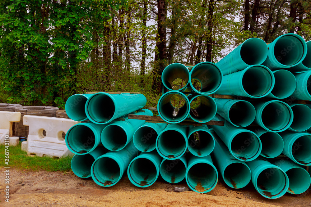 Pallets of green sewer pipes at construction for drainage system Pallets of green sewer pipes at construction for drainage system