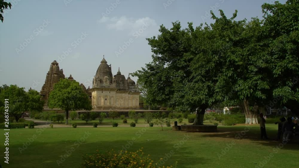 A hand held, long shot of an old, small hidden temple. A hand held, long shot of an old, small hidden temple.