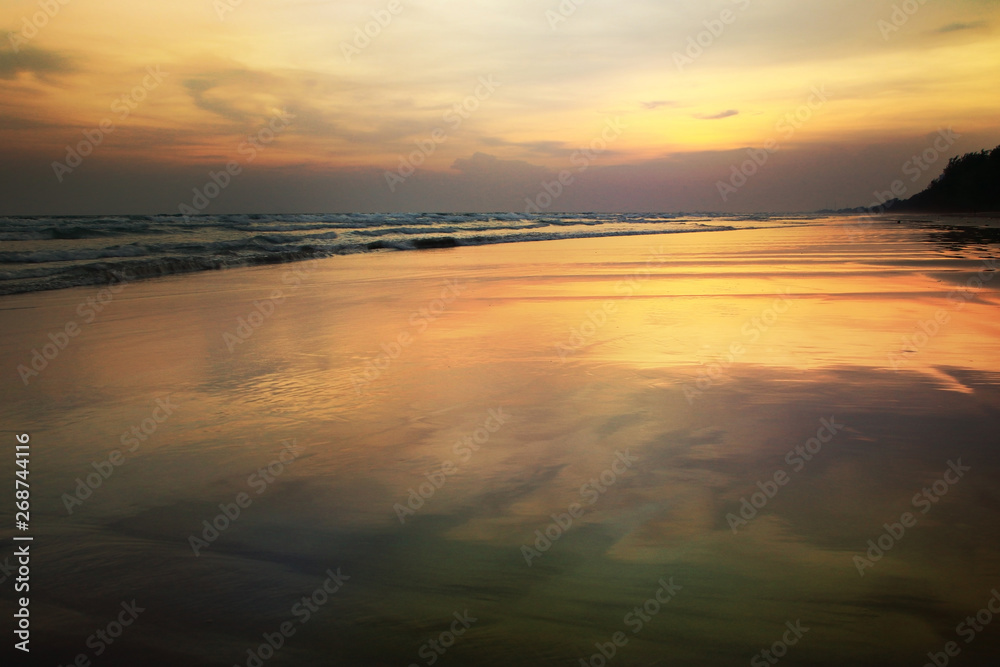 Reflections on the beach at sunset background