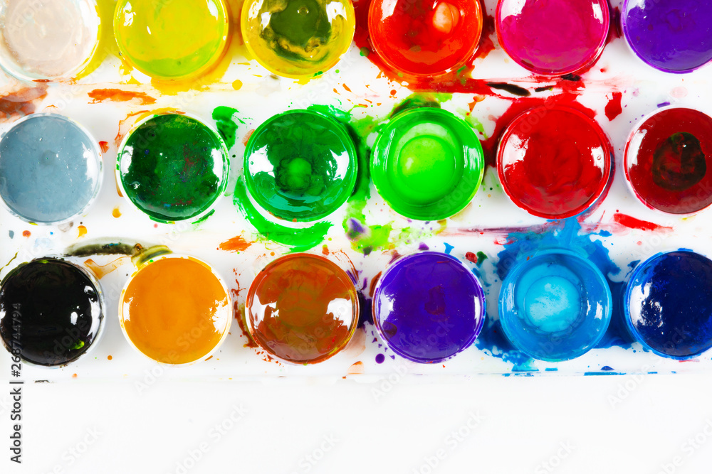 A set of children's paints in circular forms close-up. Copy space for text