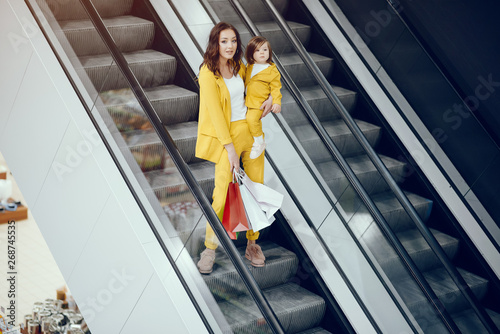 Beautiful girl in a shopping center. Lady with shopping bags. Mother with daughter in stylish clothes