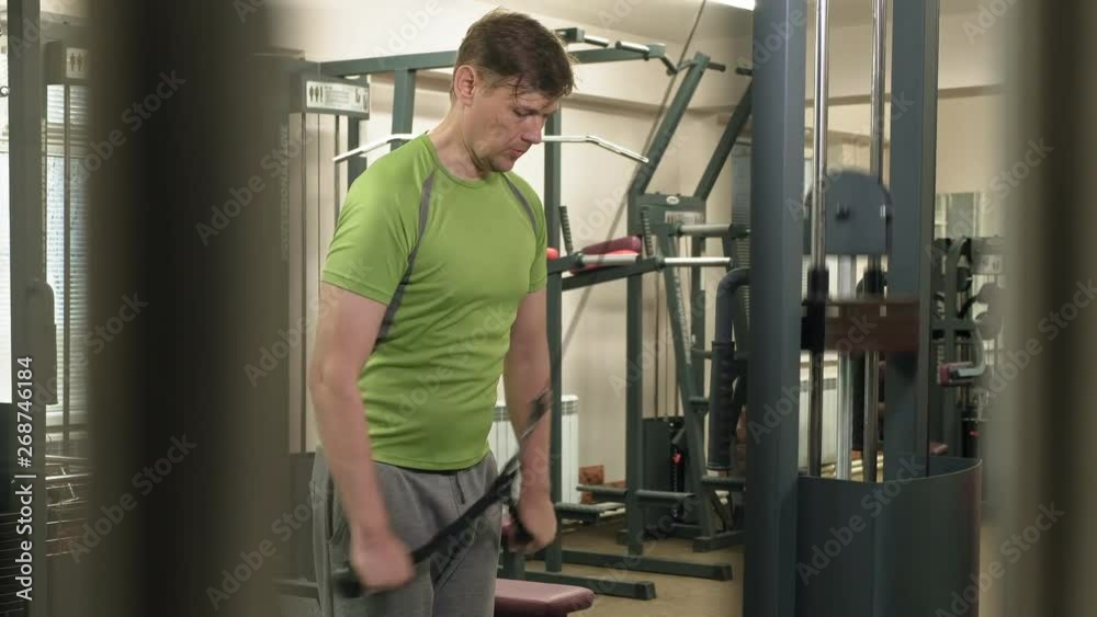 Man doing triceps exercises in the gym Man doing triceps exercises in the gym