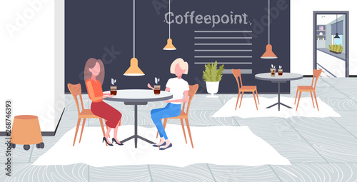 two girls discussing during meeting break for drink at work business time communication concept businesswomen sitting at cafe table modern coffee point interior flat full length horizontal