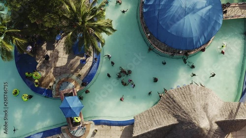 People having fun in the swimming pool of the water park in summer photo
