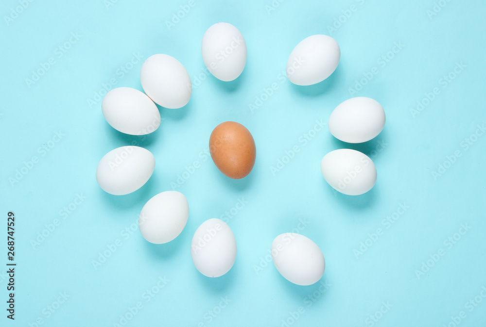 Bullying concept with eggs on a blue background. Top view, minimalism Bullying concept with eggs on a blue background. Top view, minimalism