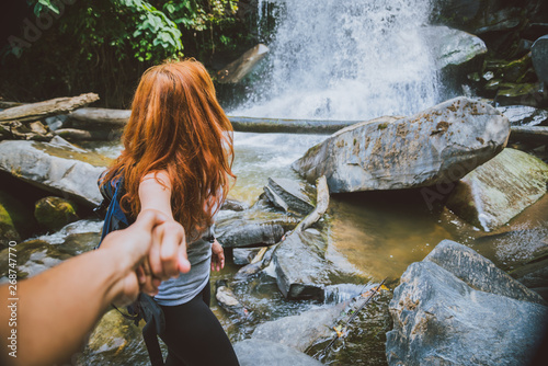 Male and woman couples asia. Walking hand travelers travel nature Forests, mountains, waterfalls. Travel Siliphum Waterfall at Chiangmai, in  Thailand. photo