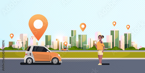african woman using mobile app ordering automobile vehicle with location mark rent car sharing concept transportation carsharing service modern cityscape background horizontal
