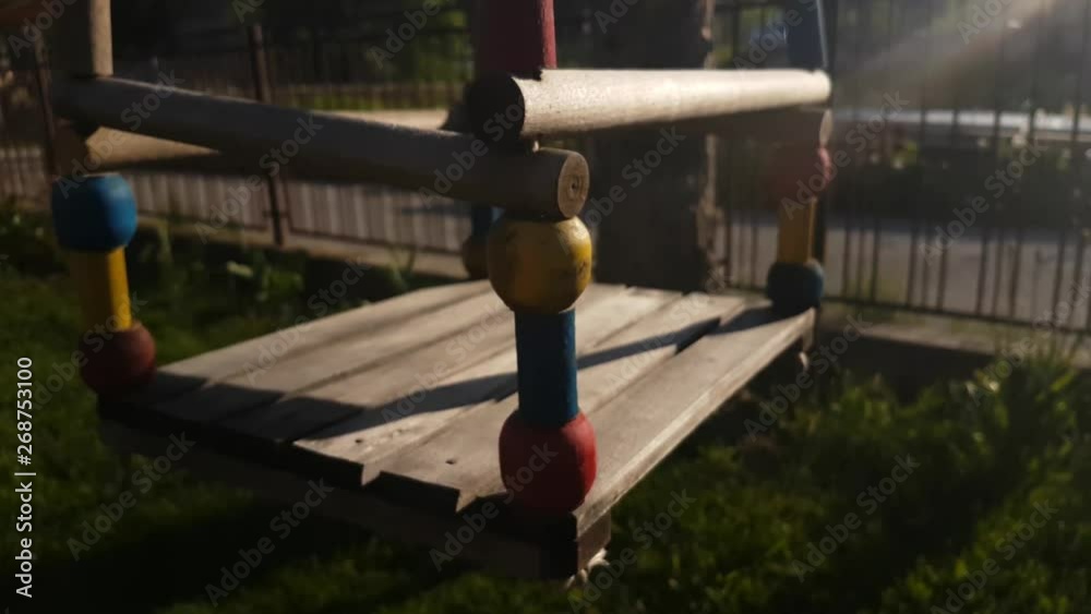 Empty Child Wooden Swing Waving in Outdoor Playground Under Evening Sun Close Up 4k Empty Child Wooden Swing Waving in Outdoor Playground Under Evening Sun Close Up 4k