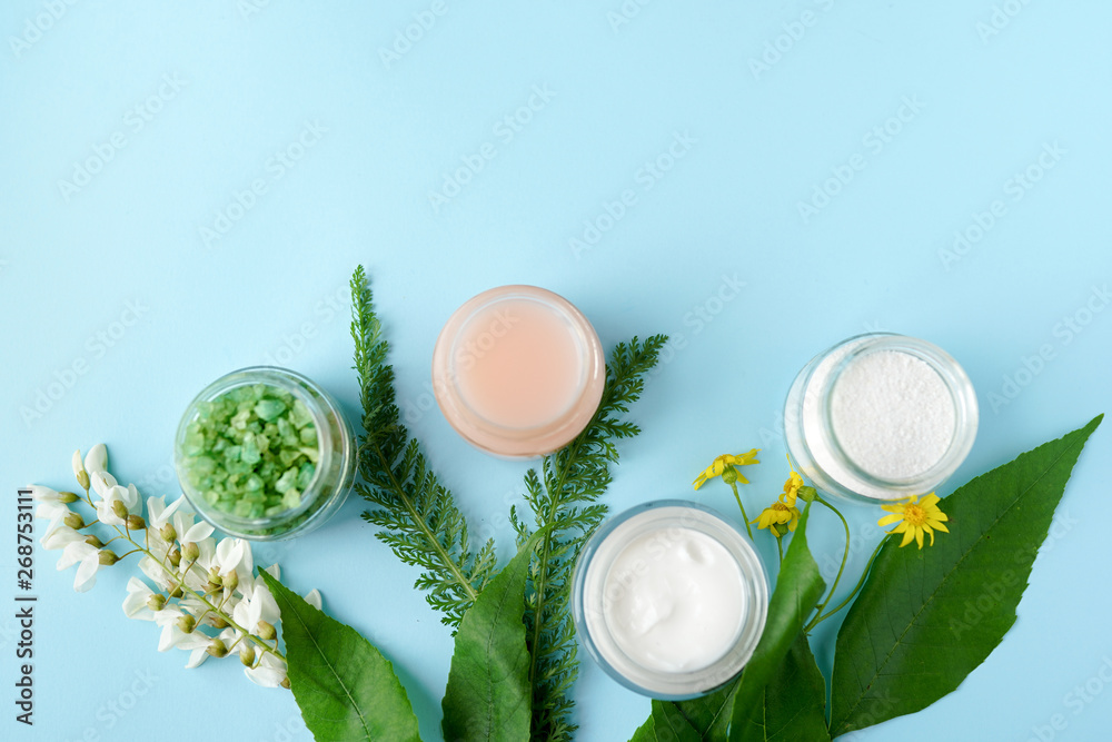 Spa cosmetic products concept, blue background with a space for a text, flat lay, view from above Spa cosmetic products concept, blue background with a space for a text, flat lay, view from above